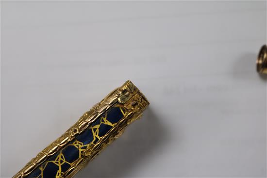 An early 20th century continental gold overlaid enamelled glass scent bottle, 75mm.